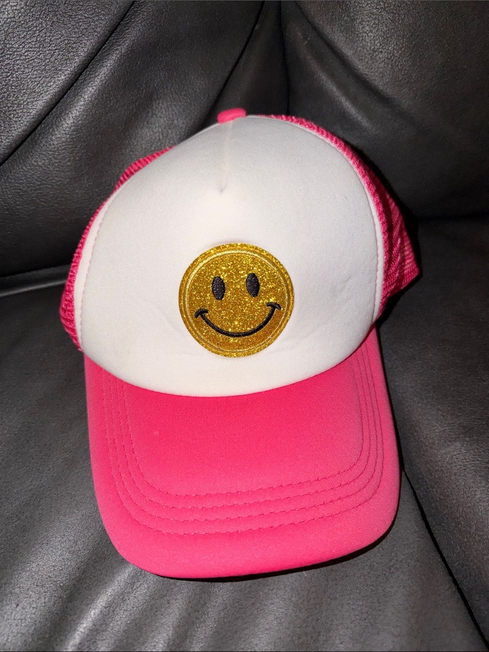 Pink and White Trucker Hat with Gold Smiley Patch